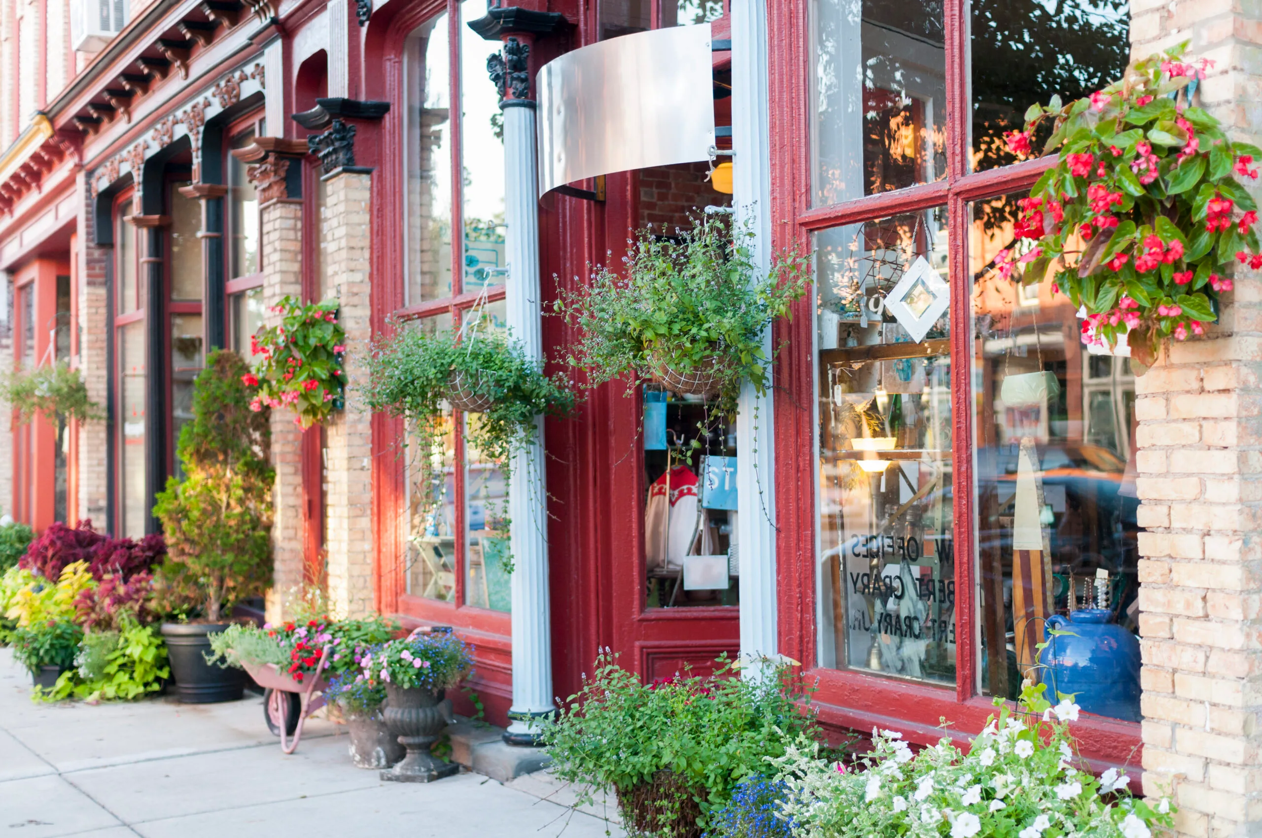 A row of small-town boutiques with red shopfronts.