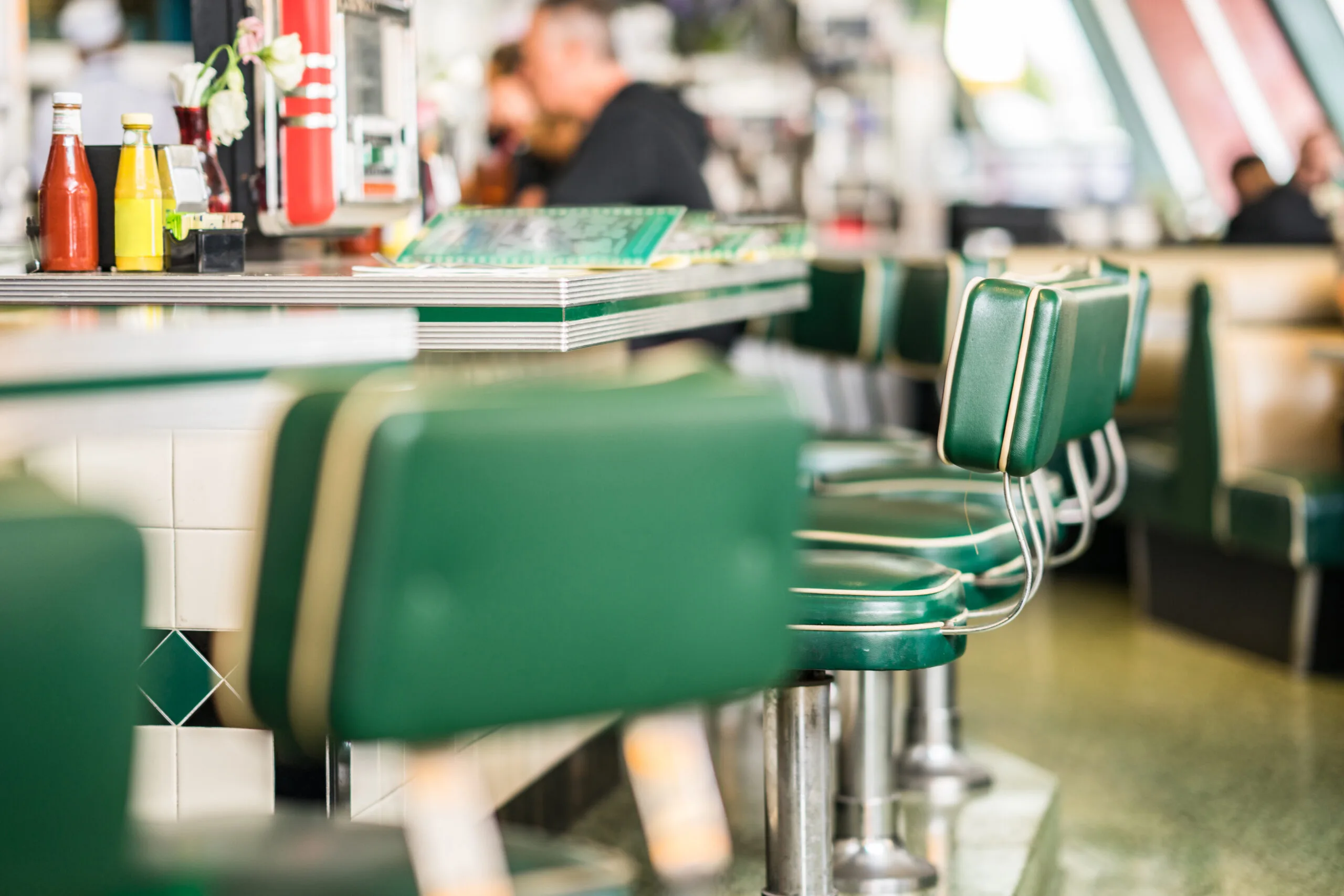 Retro diner with green high stools.
