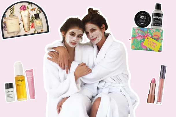 Cindy crawford and kaia gerber posing together in robes and face masks surrounded by beauty gift sets