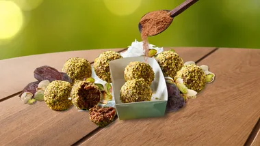 Pistachio date energy balls on a wooden table