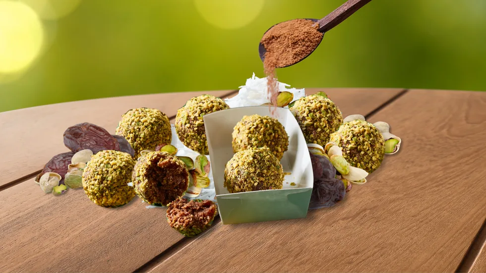 Pistachio date energy balls on a wooden table