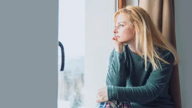 Woman looking out window