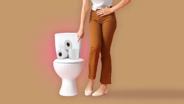 Woman standing beside a toilet