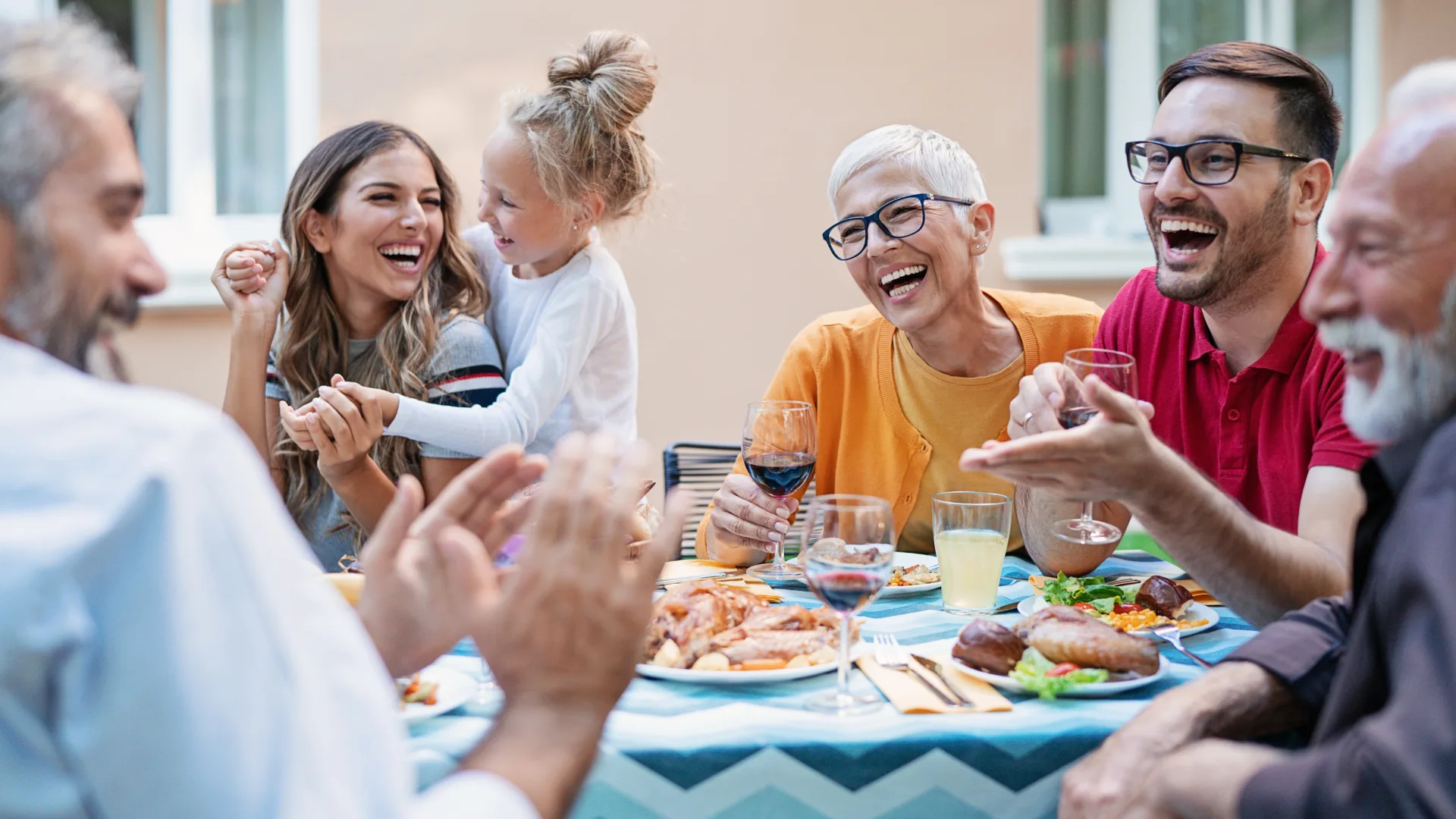 Family laughing around a dinner table