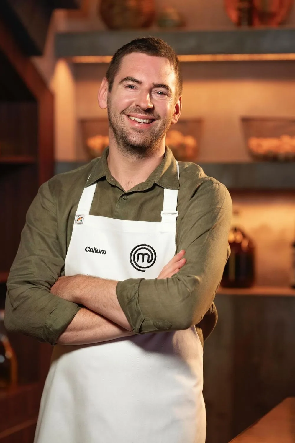 MasterChef star Callum Hann wearing an apron on the show