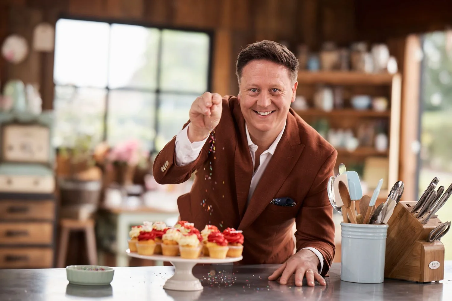 Darren Purchese with a plate of fairy cakes on The Great Australian Bake Off