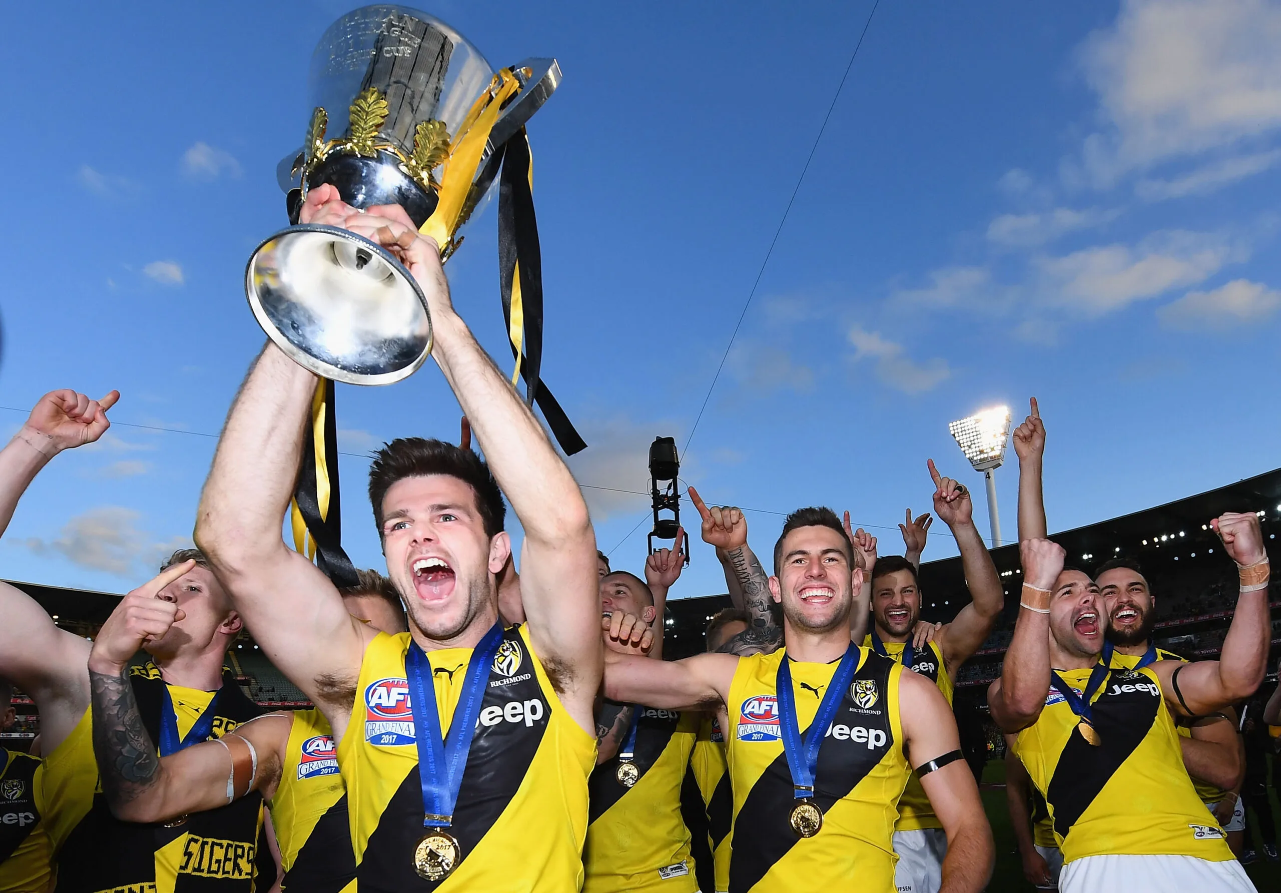 Trent Cotchin holding AFL Grand Final trophy.