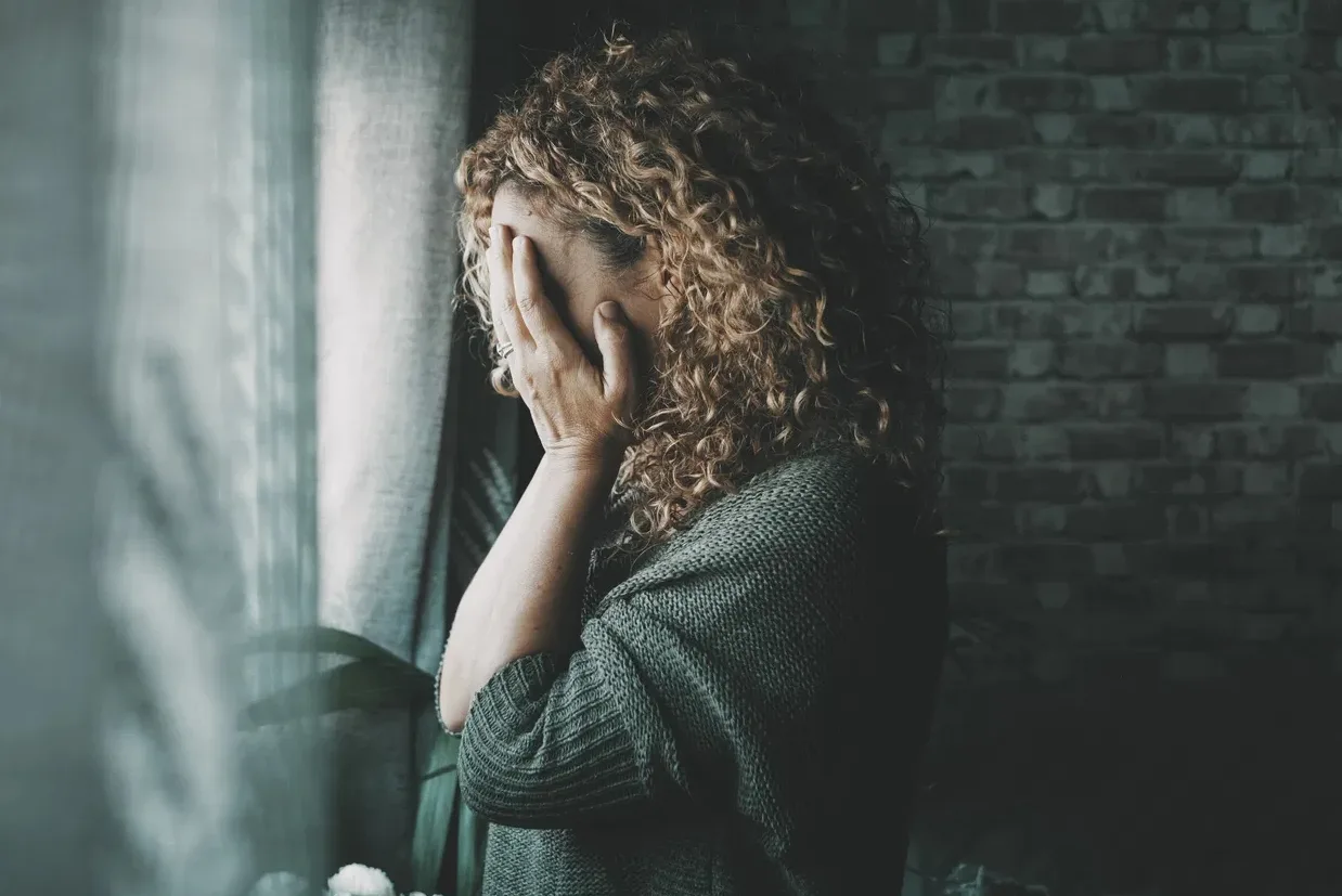 Woman with face in her hands