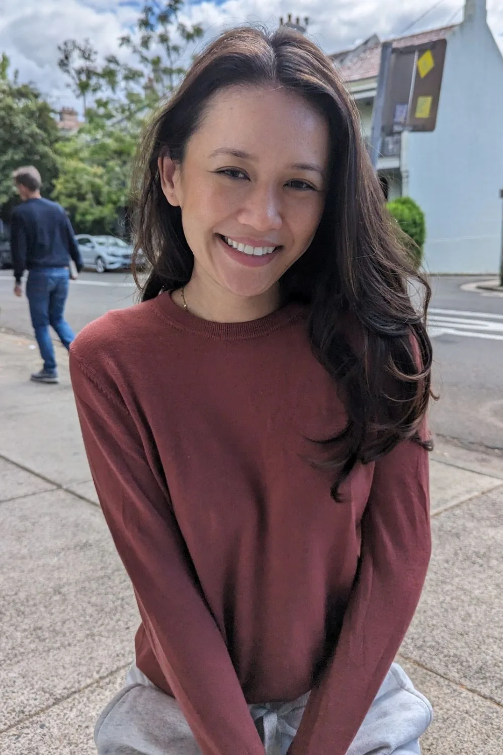 Natalie Tran stands in the street smiling at the camera