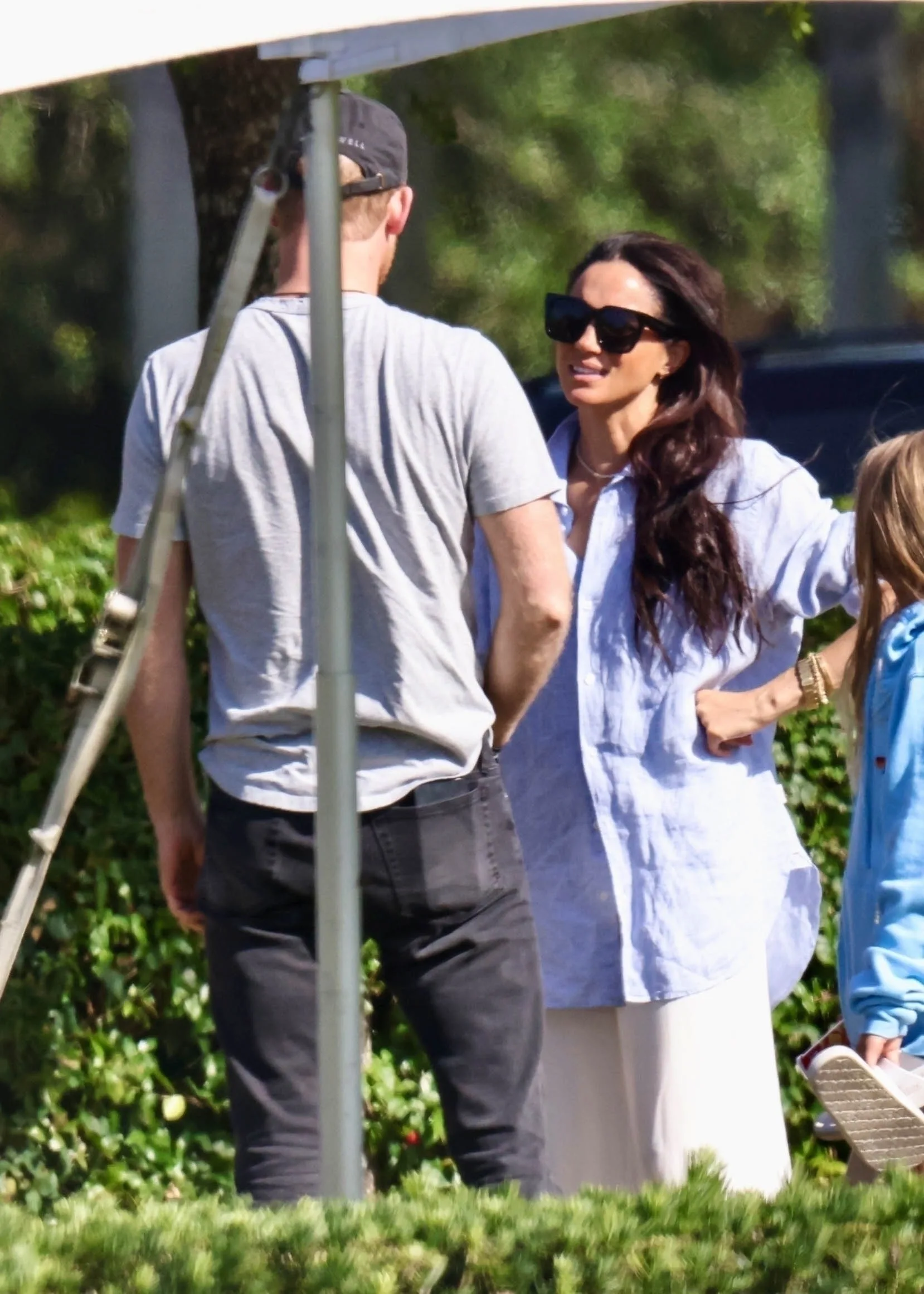 Prince Harry from behind and Meghan Markle.