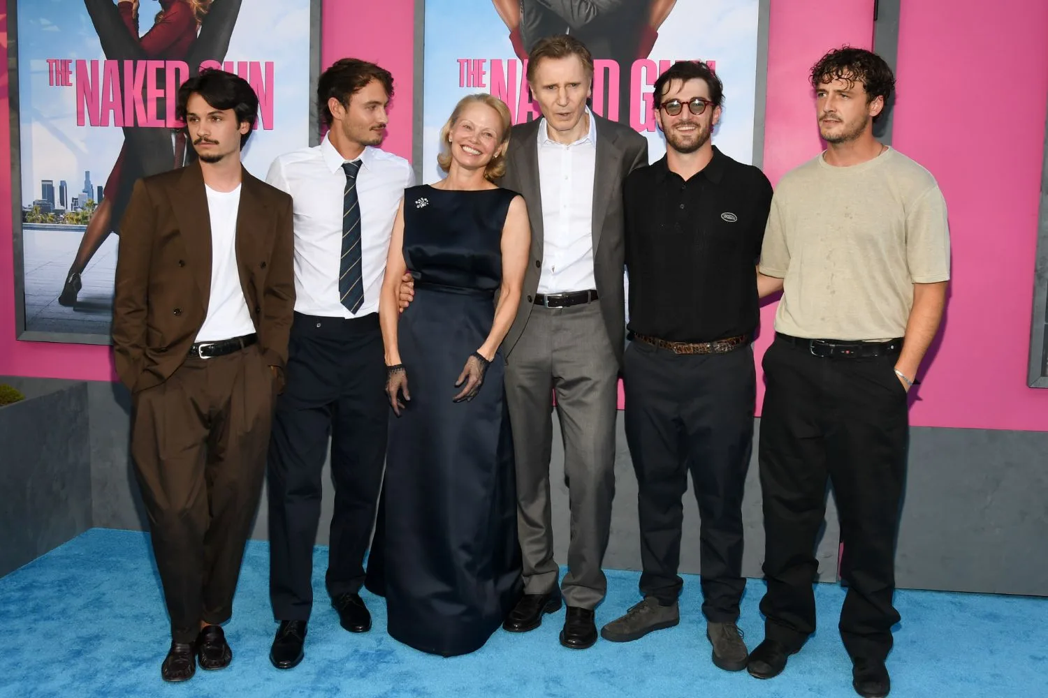 Liam Neeson and Pamela Anderson poses with their respective sons on the red carpet
