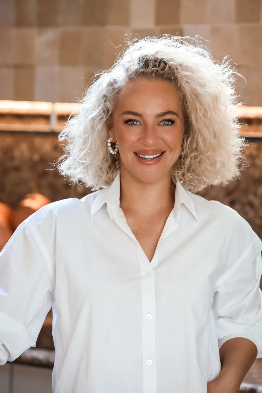 Ash Pollard poses for a portrait in the kitchen