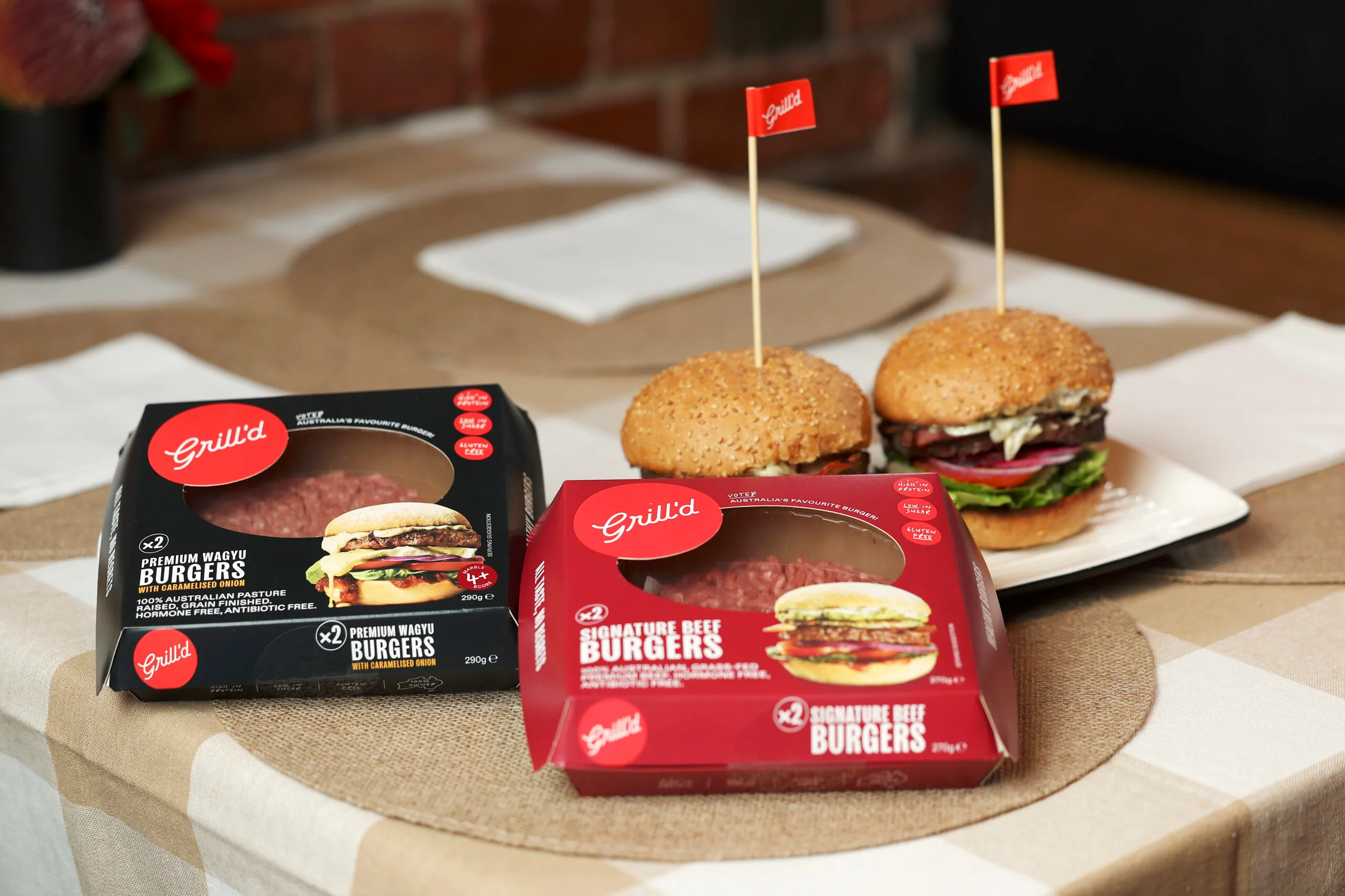 Grill'd burger patties, alongside two Grill'd burgers in-store