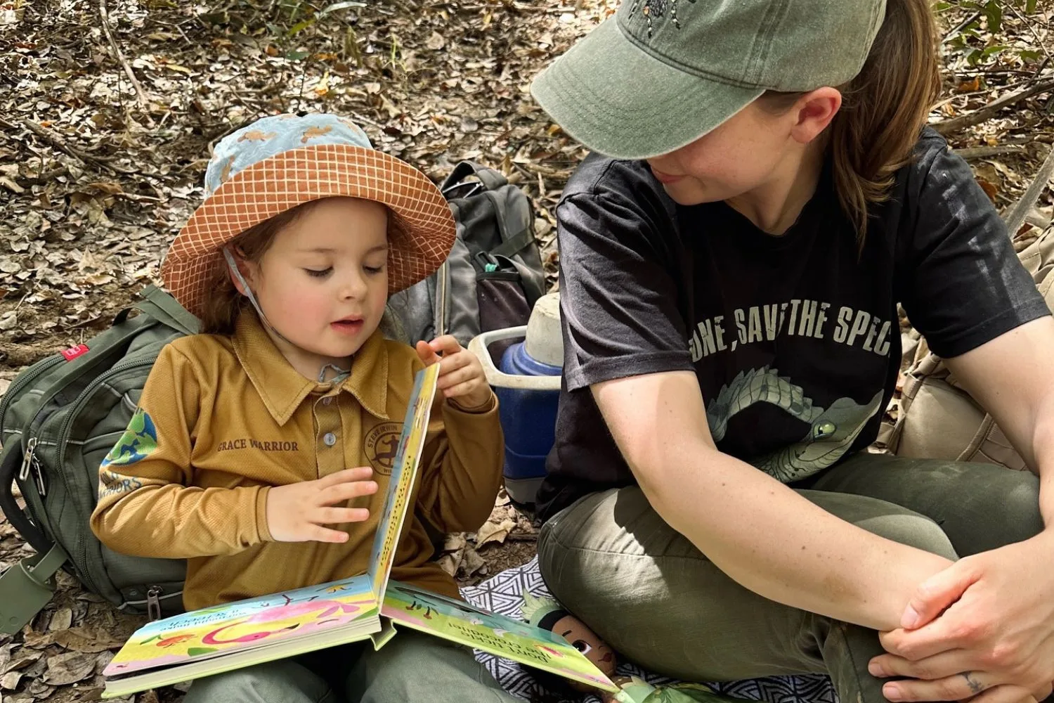 Bindi Irwin's daughter Grace reading a book about crocodiles