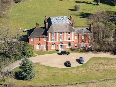 An exterior view of Forest Lodge and Kate with two of her children
