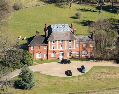 An exterior view of Forest Lodge and Kate with two of her children