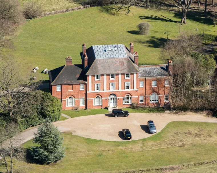 An exterior view of Forest Lodge and Kate with two of her children