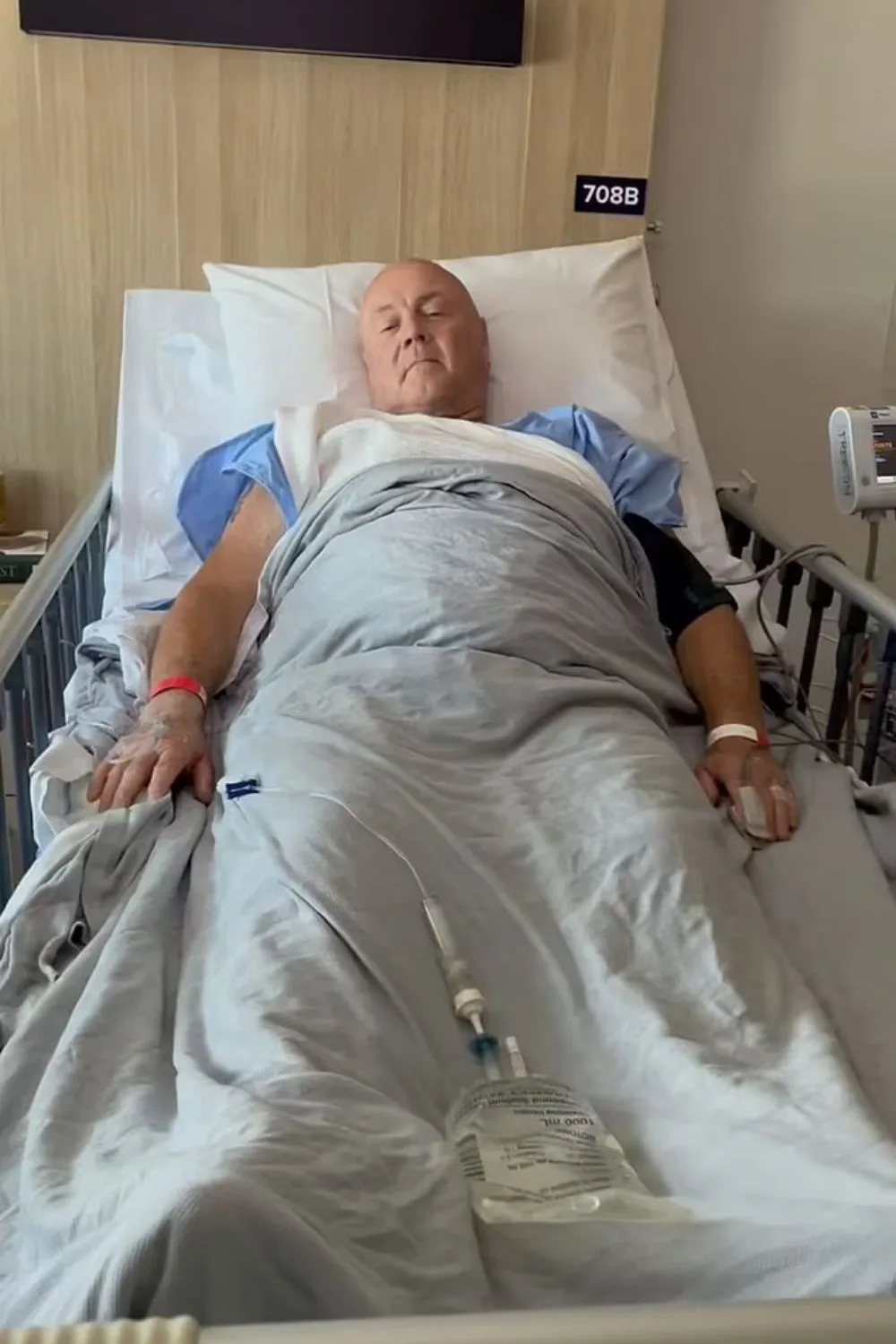 Gogglebox star Keith lying in a hospital bed hooked up to tubes and wires