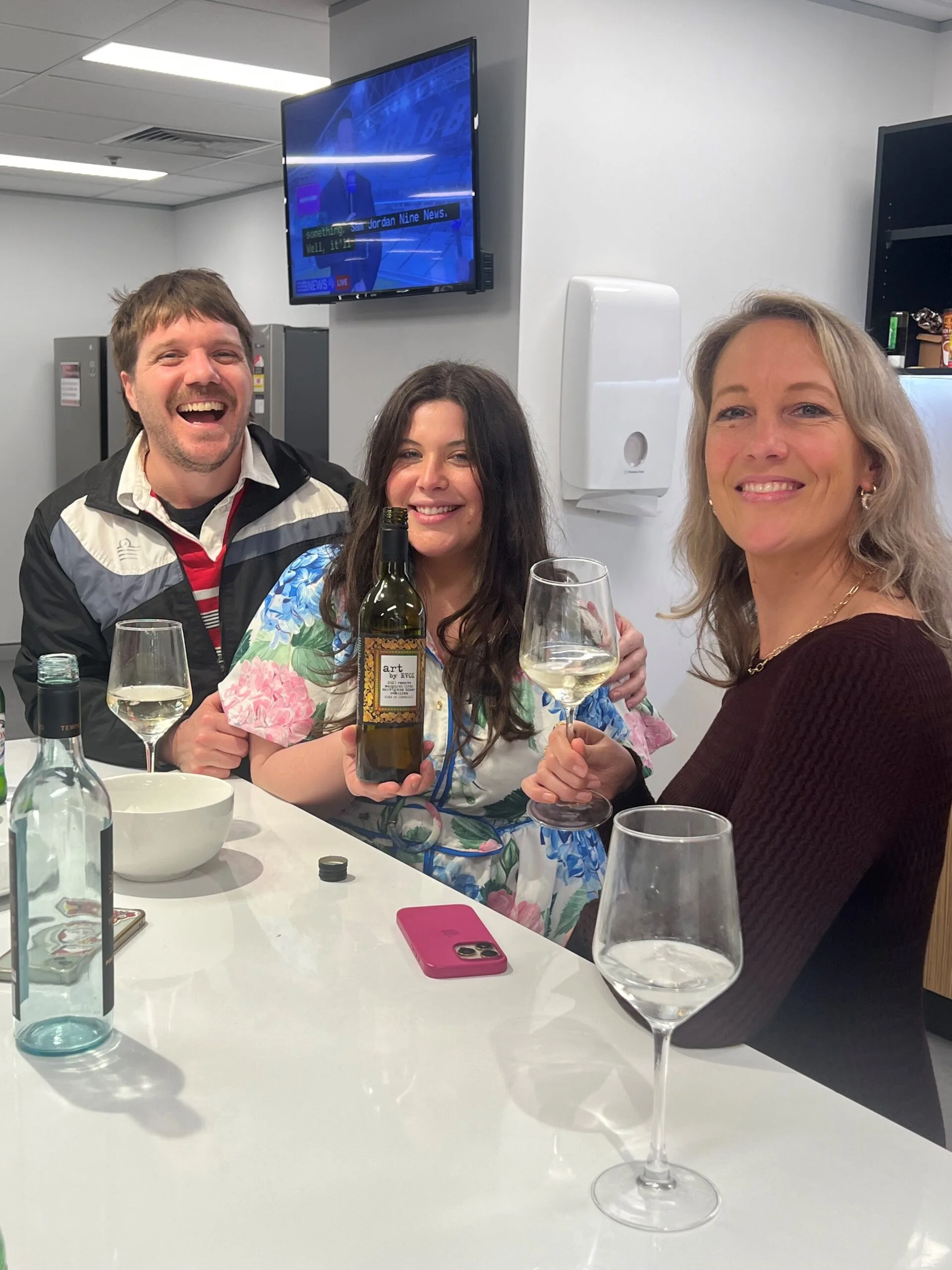 Staff tasting wine in kitchen