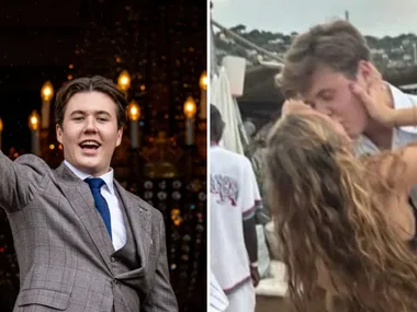 Prince Christian waves at the crowd and kisses his girlfriend at a music festival