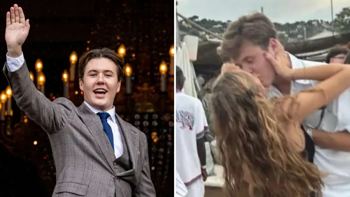 Prince Christian waves at the crowd and kisses his girlfriend at a music festival