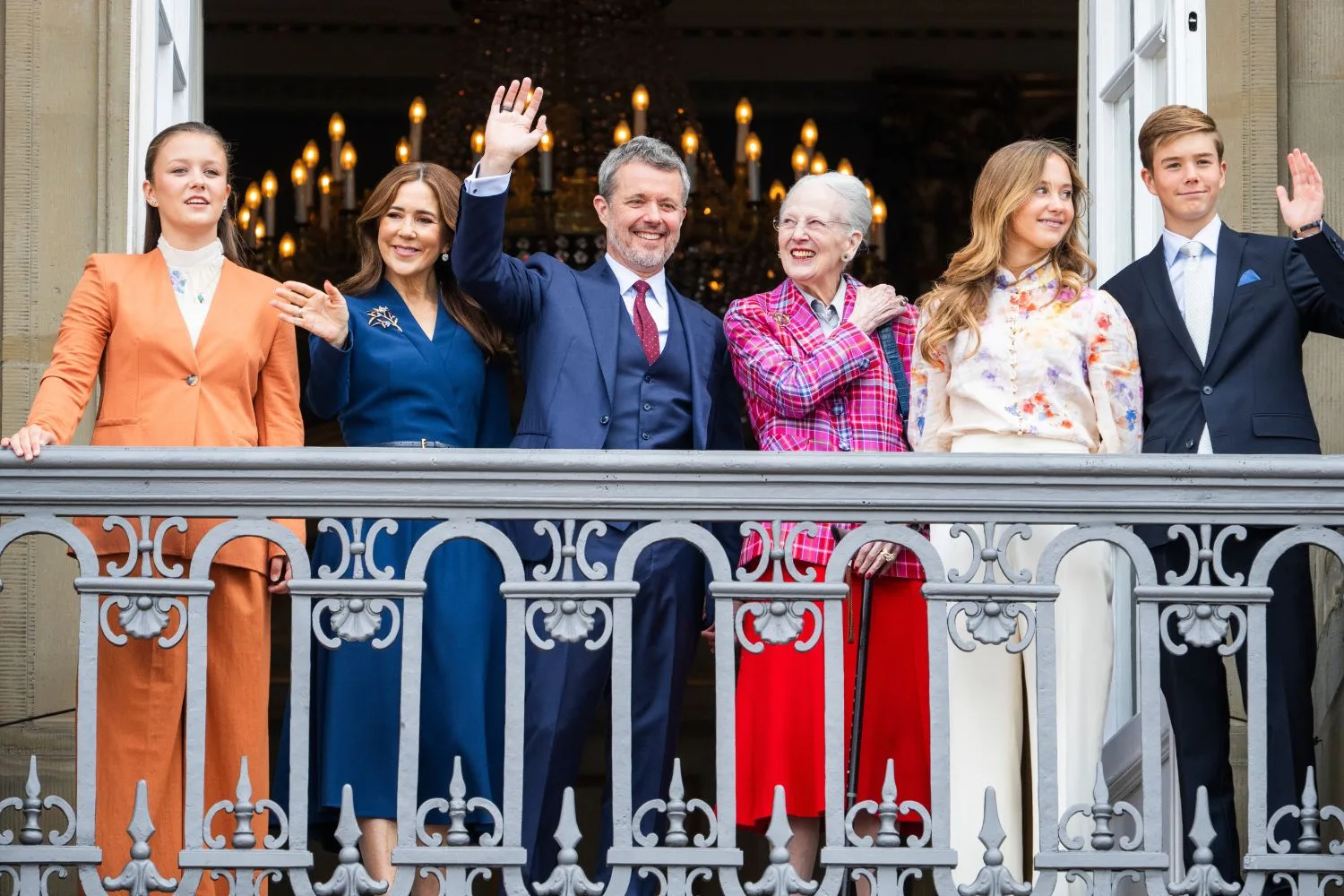 Queen Mary, King Frederik and family wave from a balcony
