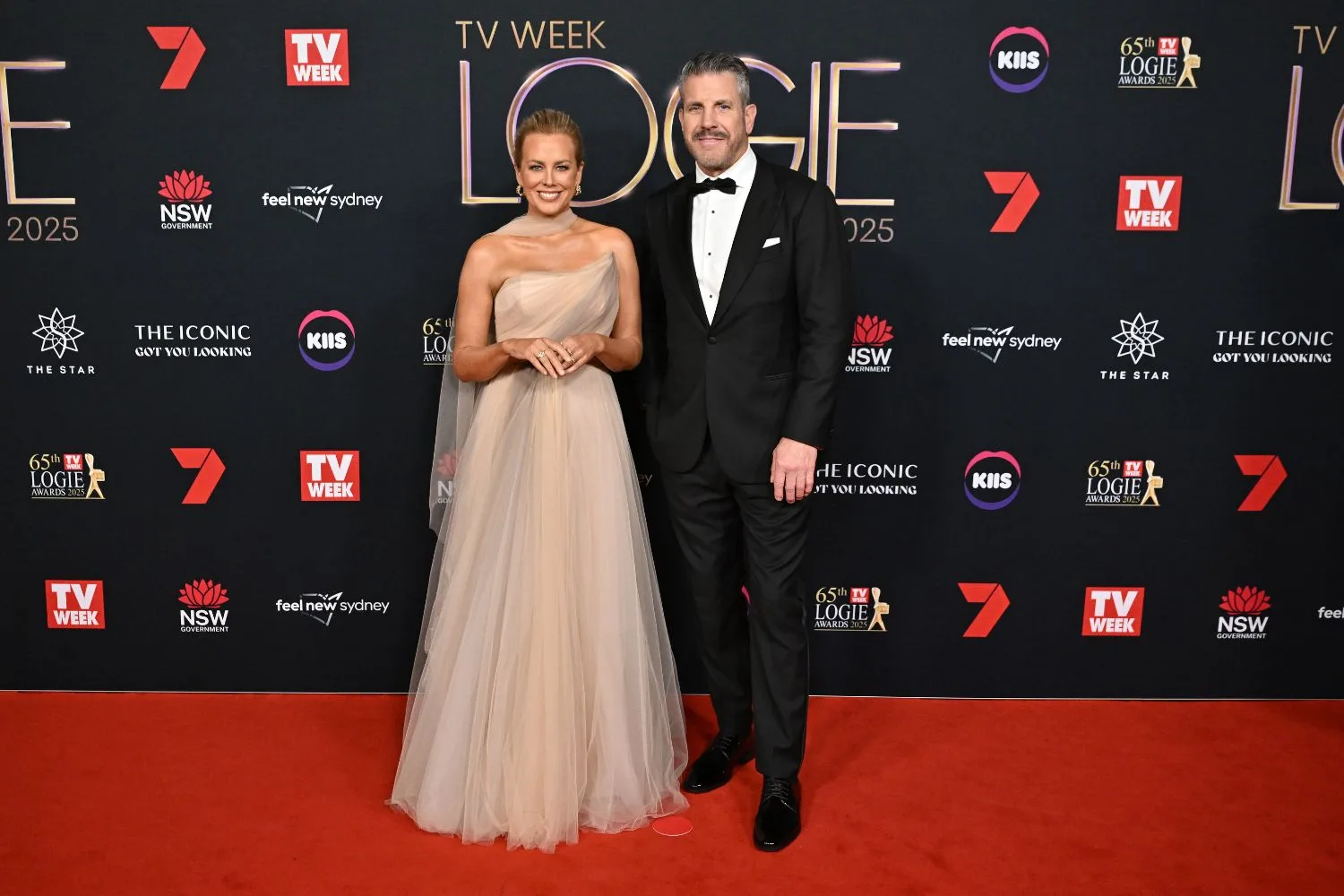 Sam Armytage poses on the red carpet at the Logies alongside the Golden Bachelor Barry 'Bear' Myrden