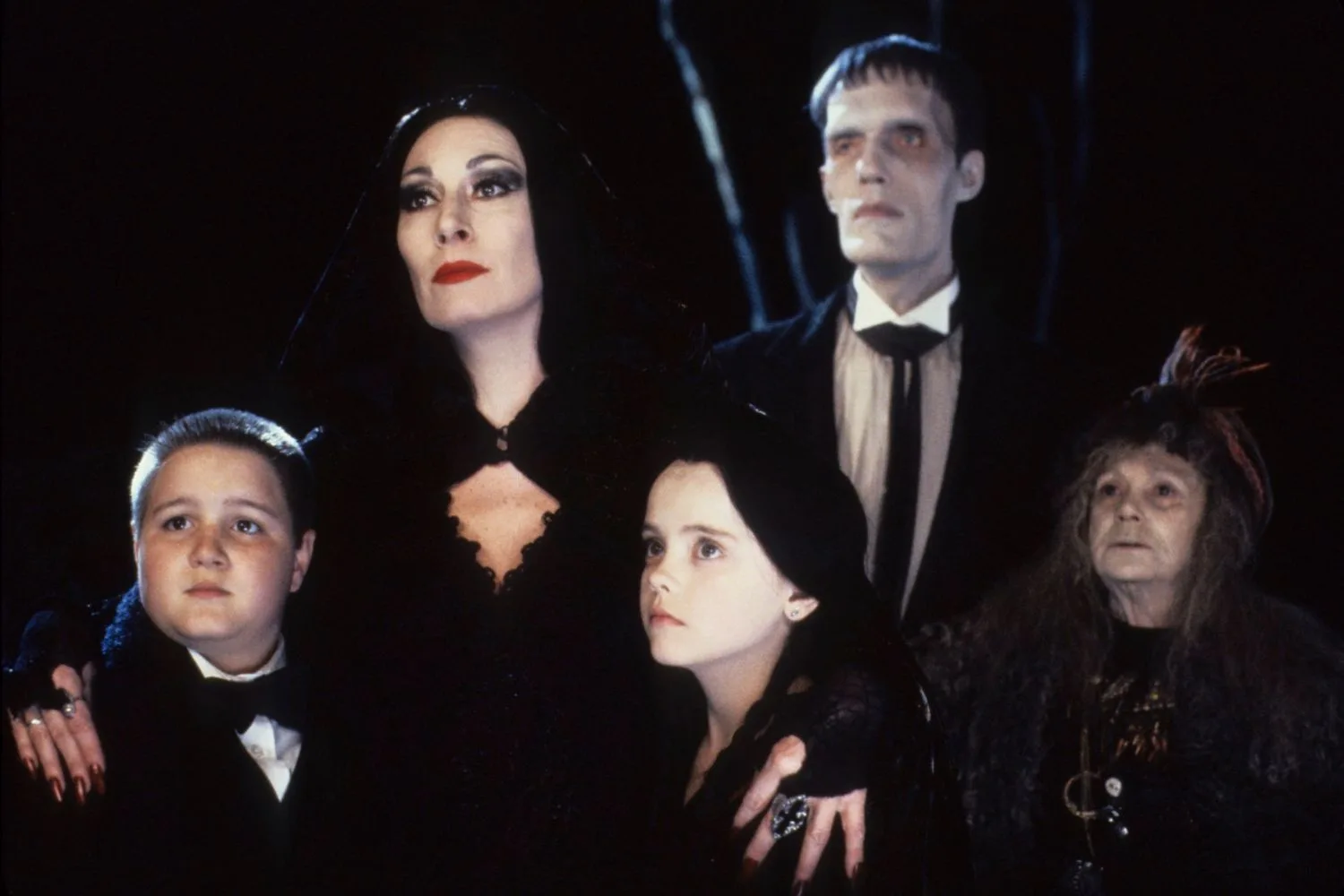The cast of The Addams Family in character dressed in black