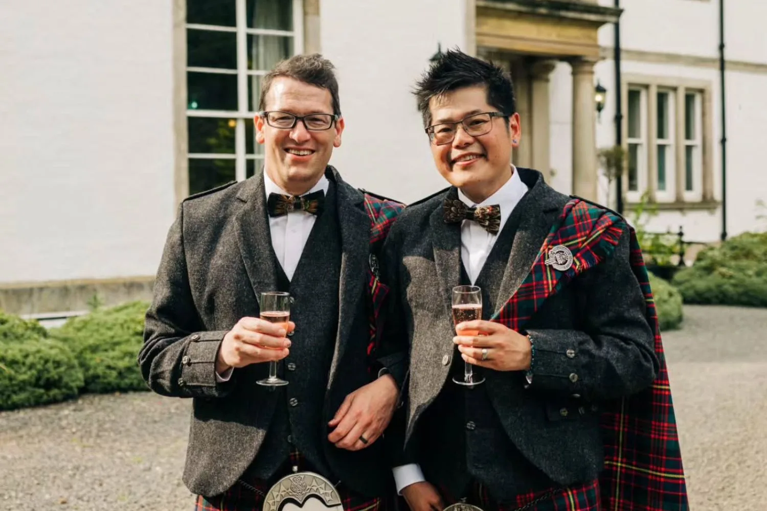 Tim and his husband Mark in kilts at their wedding celebration in Scotland