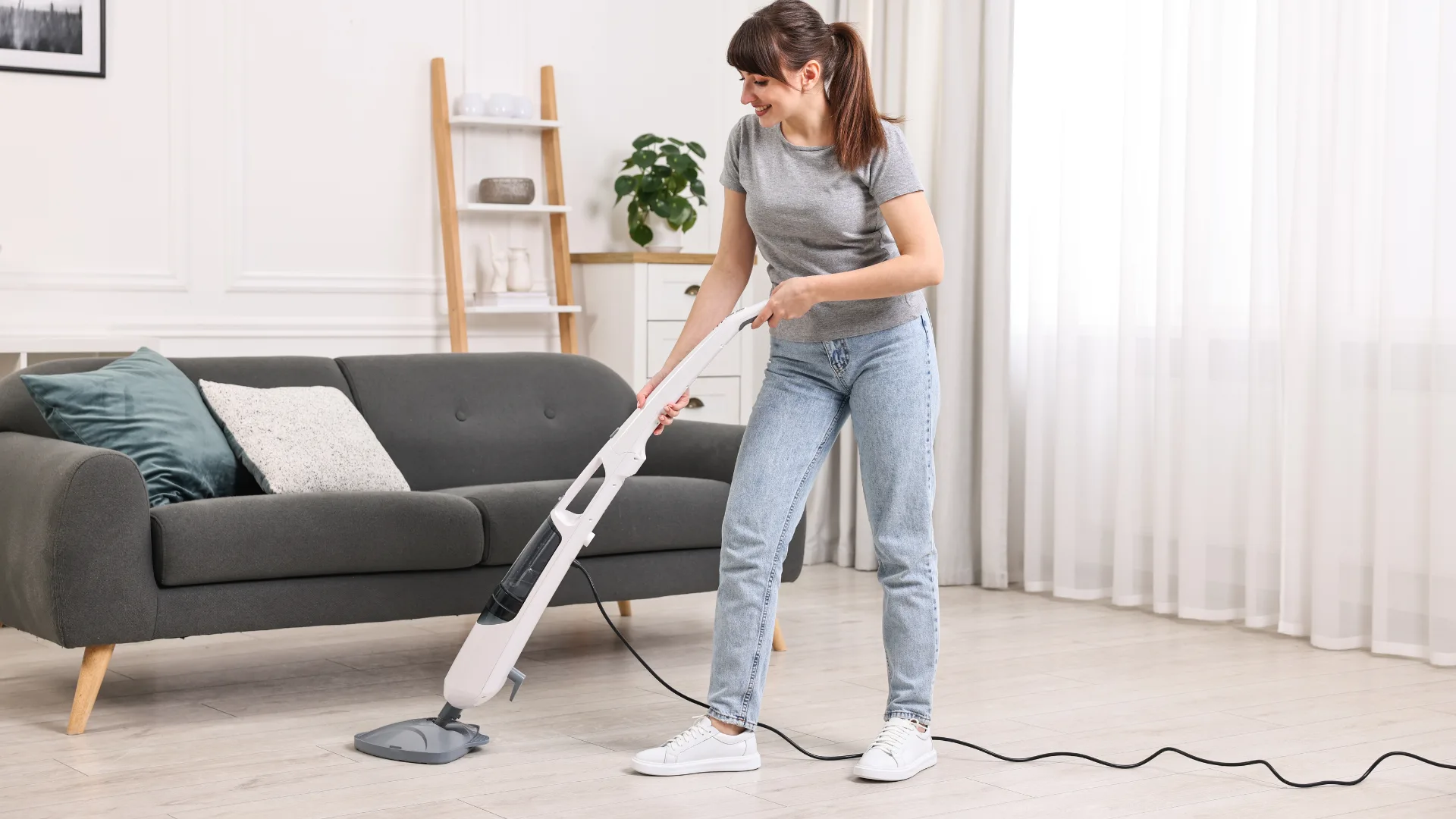 woman using steam mop in living room
