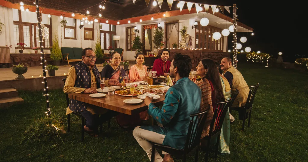 a group of people enjoying a meal outside a home