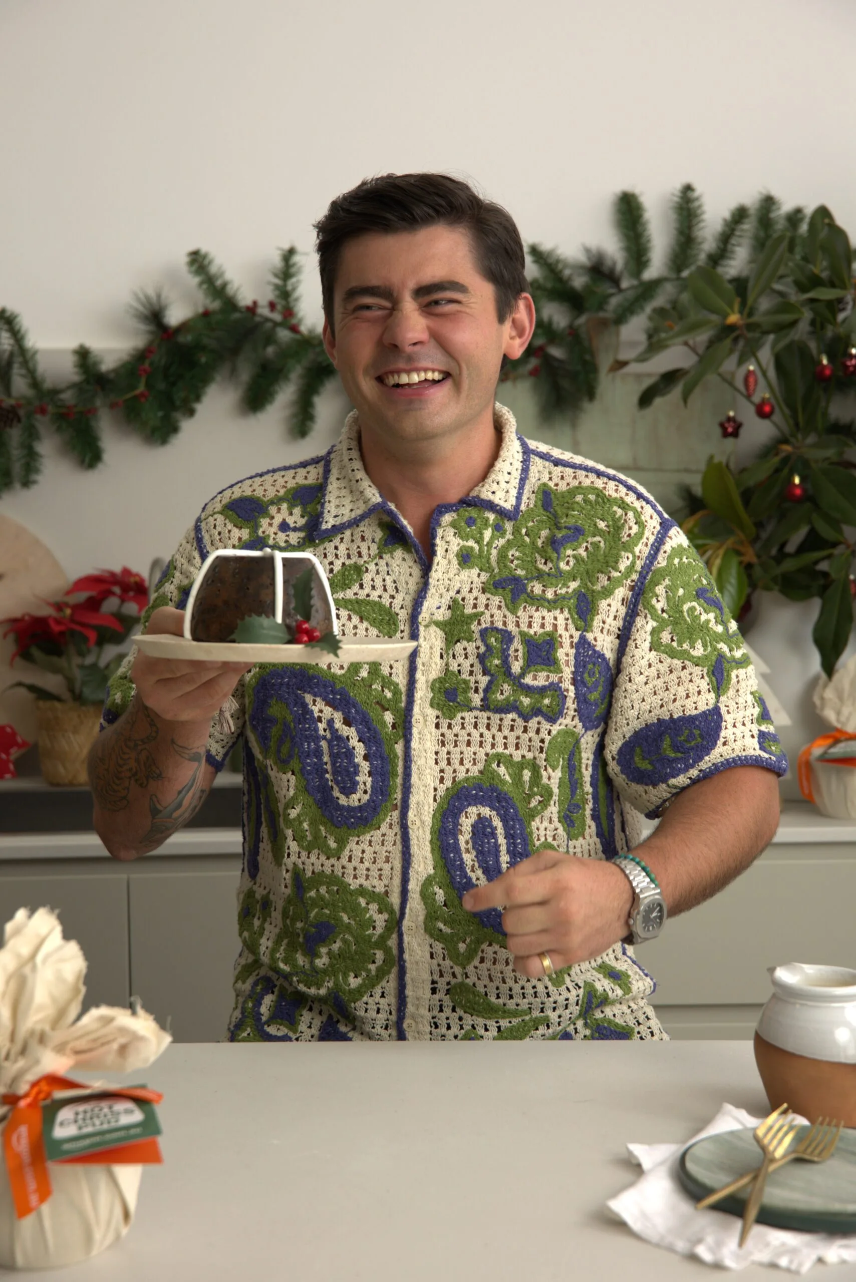 Declan Cleary holding a Hot Chriss Pud in the kitchen