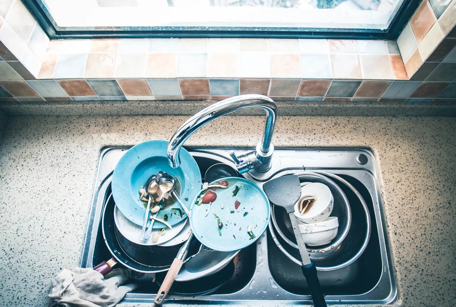 Dirty dishes in sink.