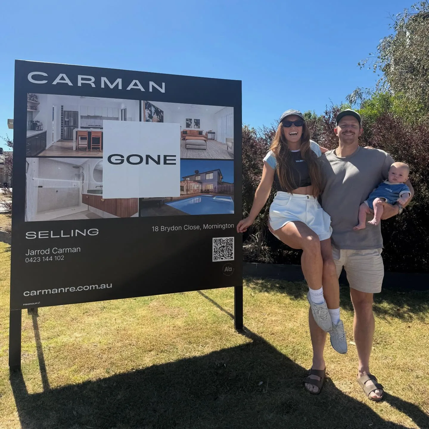 Emma and Ben The Block with Bailey with Bailey in front of Mornington sold sign