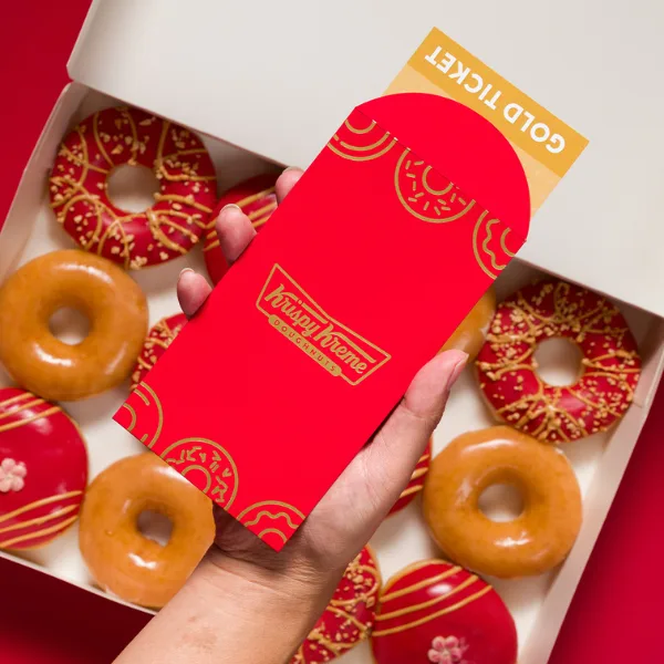 A Golden Ticket inside a Red Pocket from Krispy Kreme