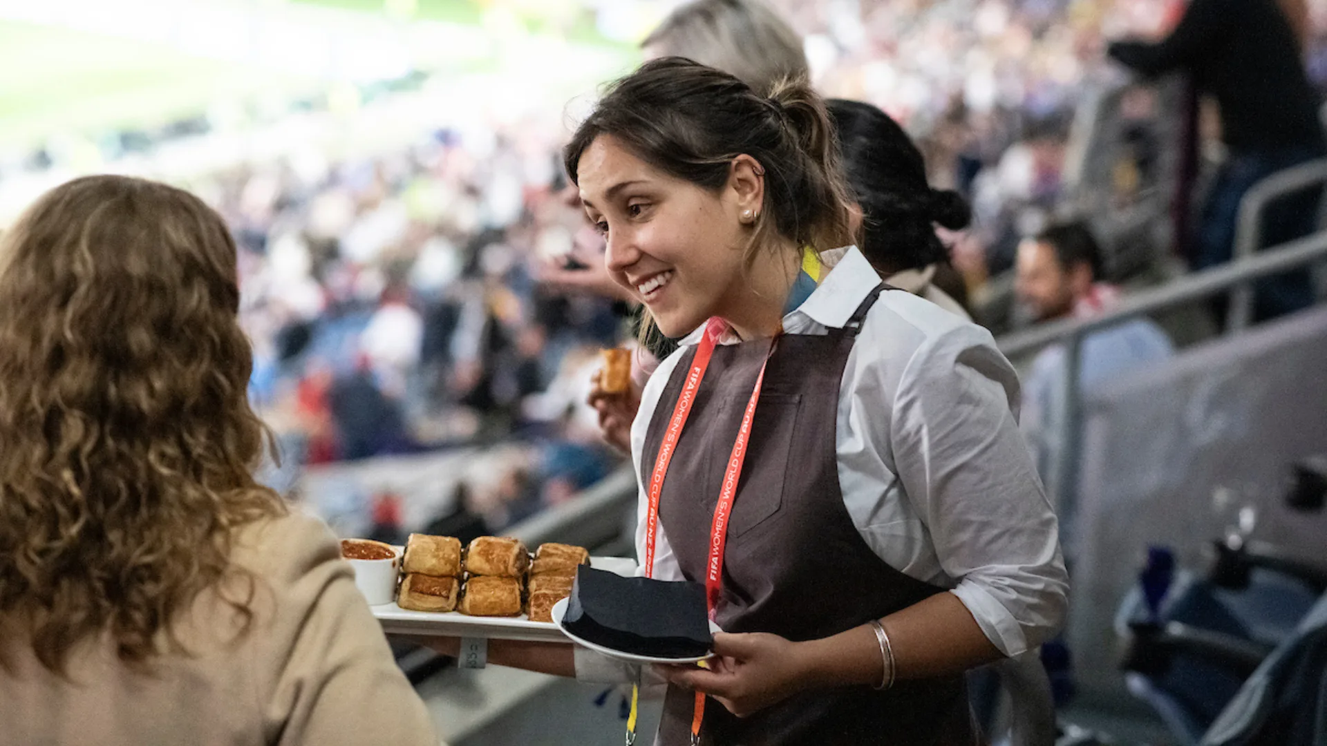 Waitress offering food in a stadium