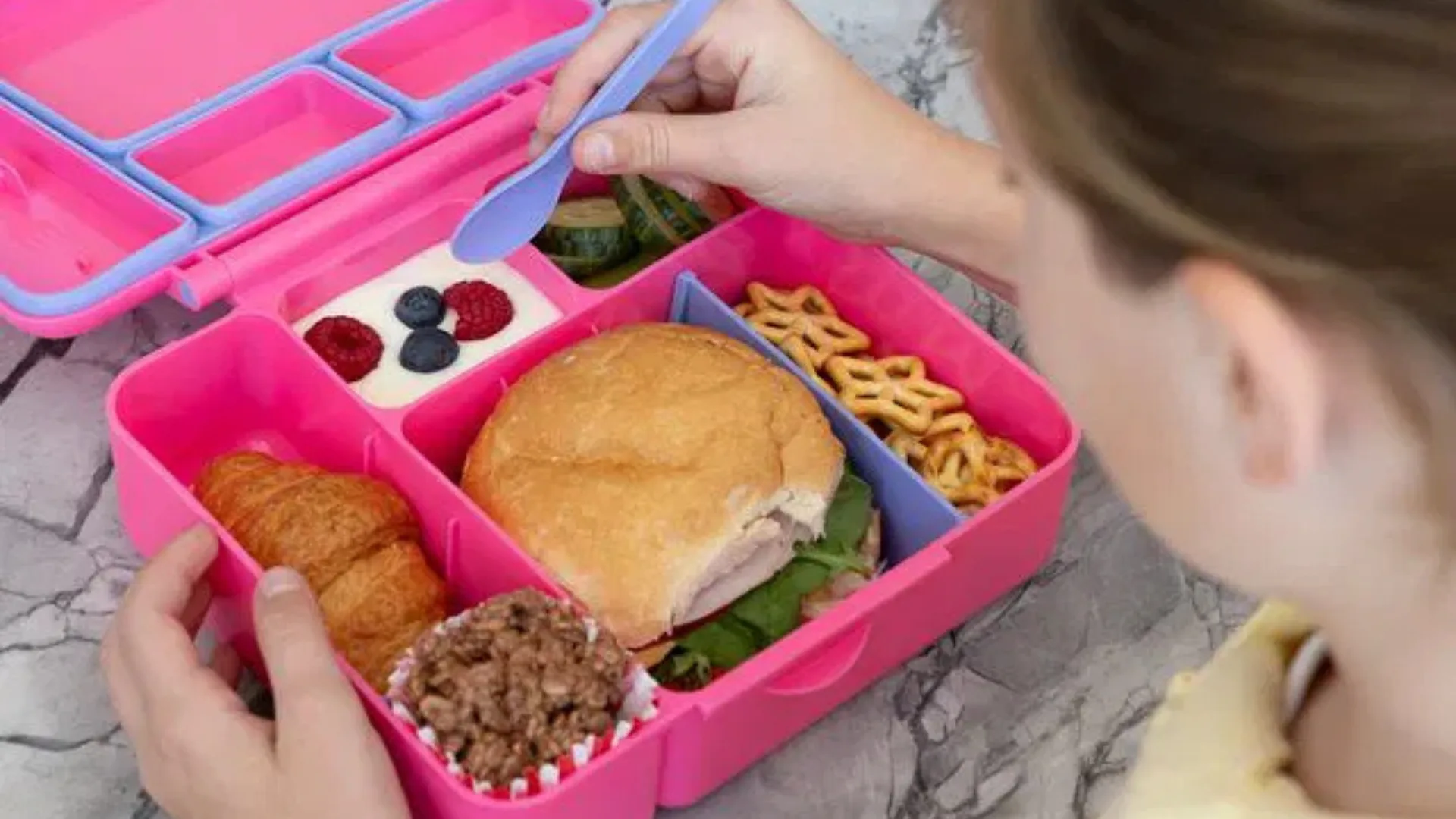 School girl eating packed lunch