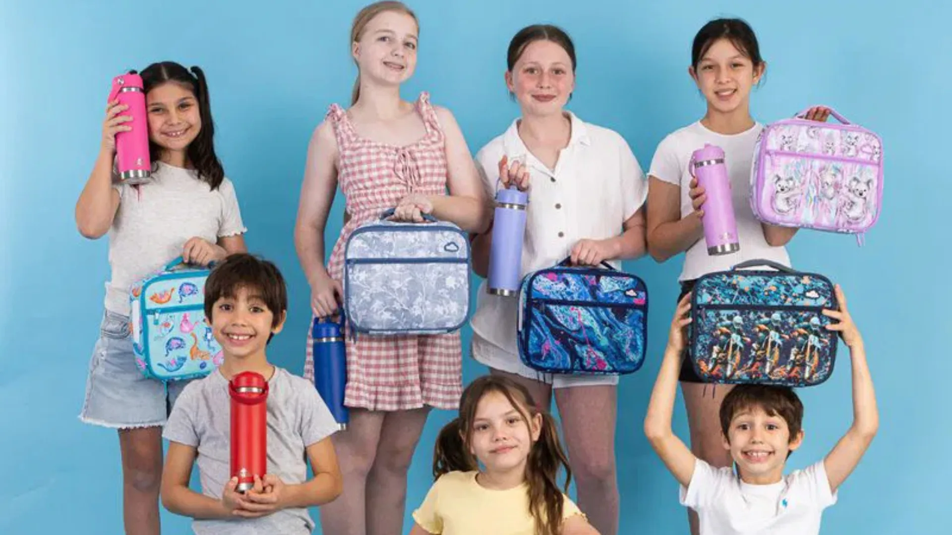 Kids holding lunch boxes