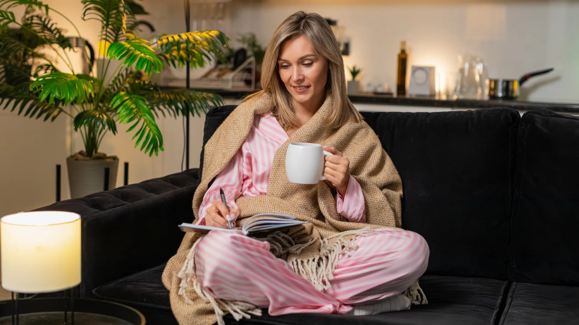 Woman drinking tea and relaxing on couch