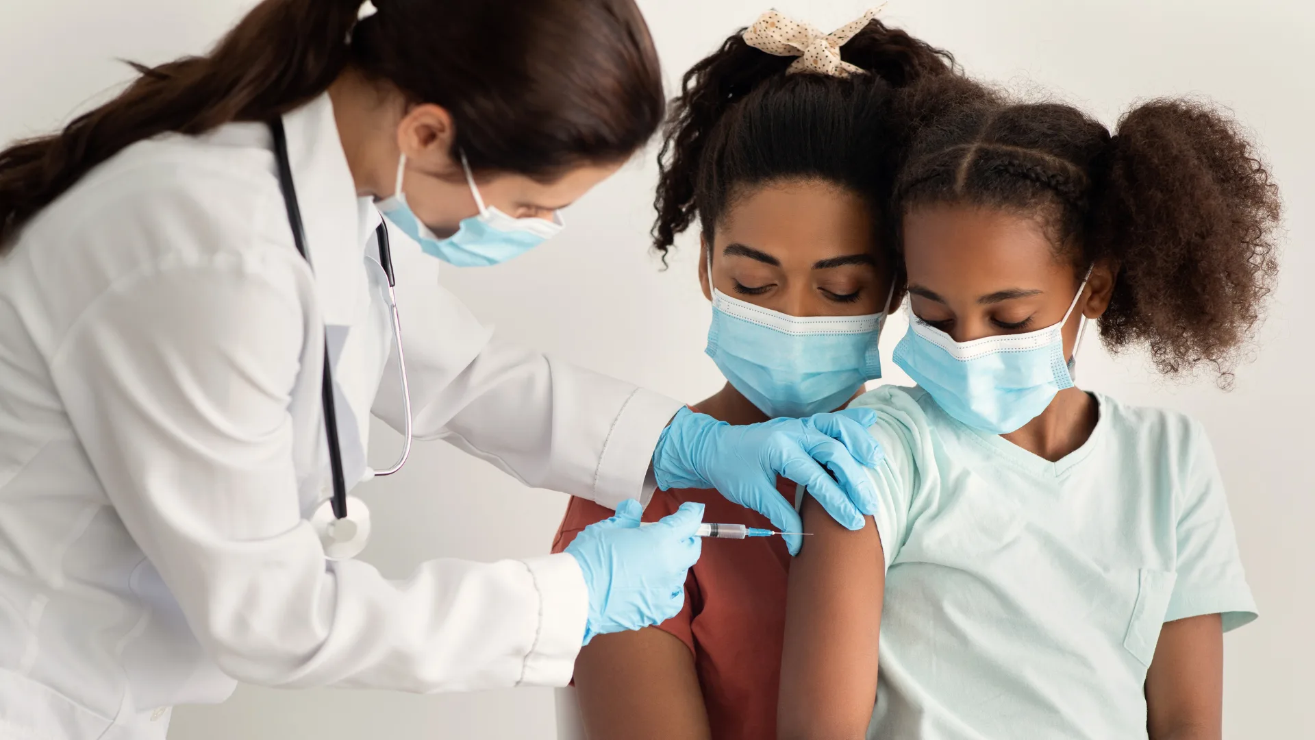 Child getting vaccinated with mother's support.