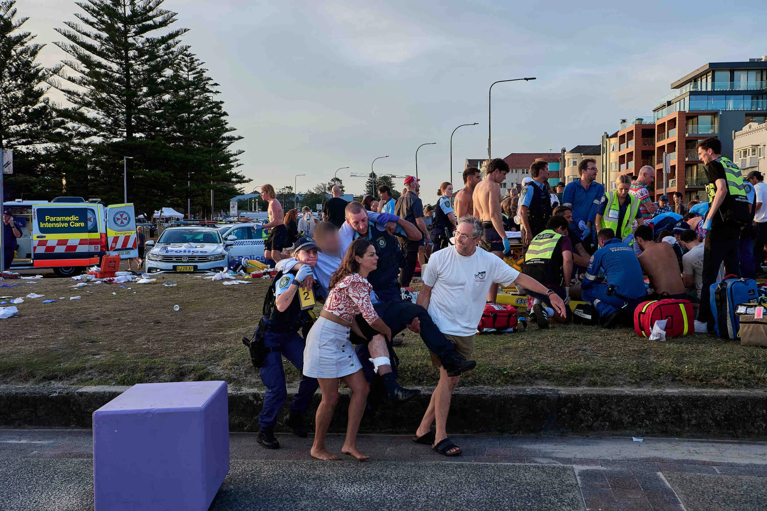 James McIntosh and Lexi Edmondson assisting an injured man during the attack.