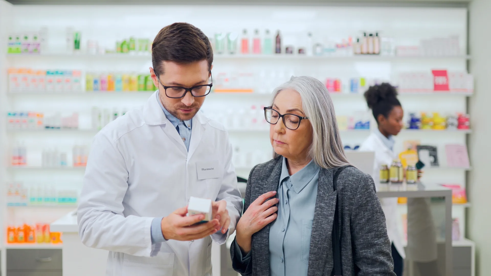 older woman speaking to a pharmacist