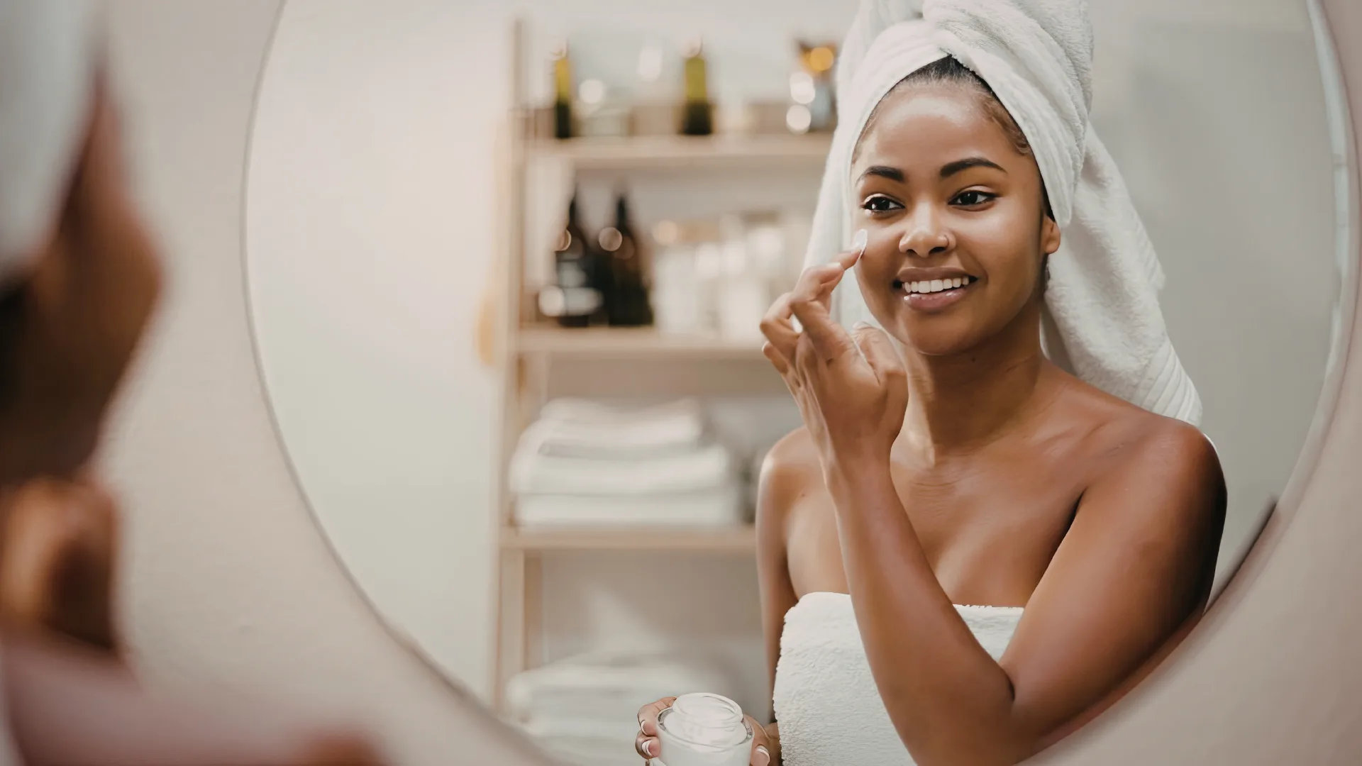 Woman in towel doing skincare routine
