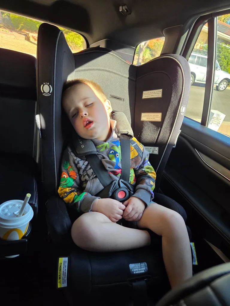 Hudson sleeping in a car seat; once an energetic three-year-old, he became often exhausted and unusually sleepy while taking the incorrectly compounded medication.