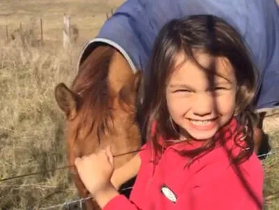 Biddy Porter with a horse and wearing a red top