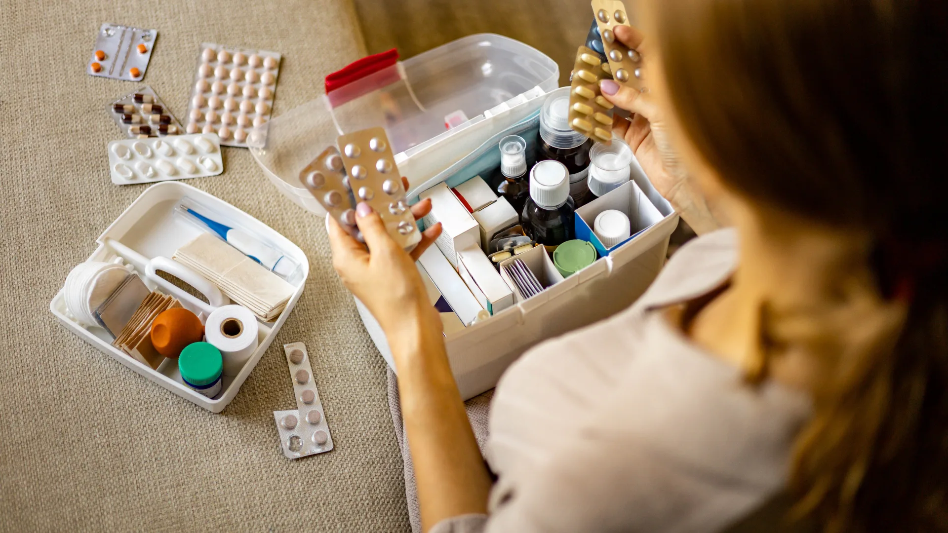 woman sorting through medical supply at home