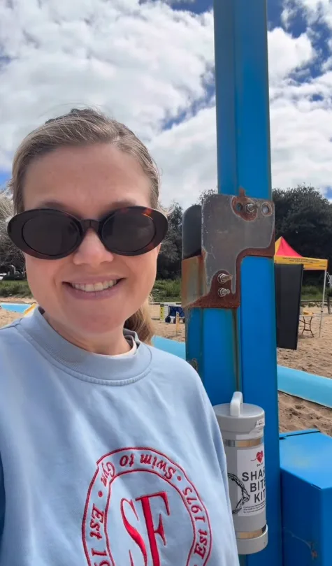 Leah Stewart shark attack survivor with shark bit kit at a beach