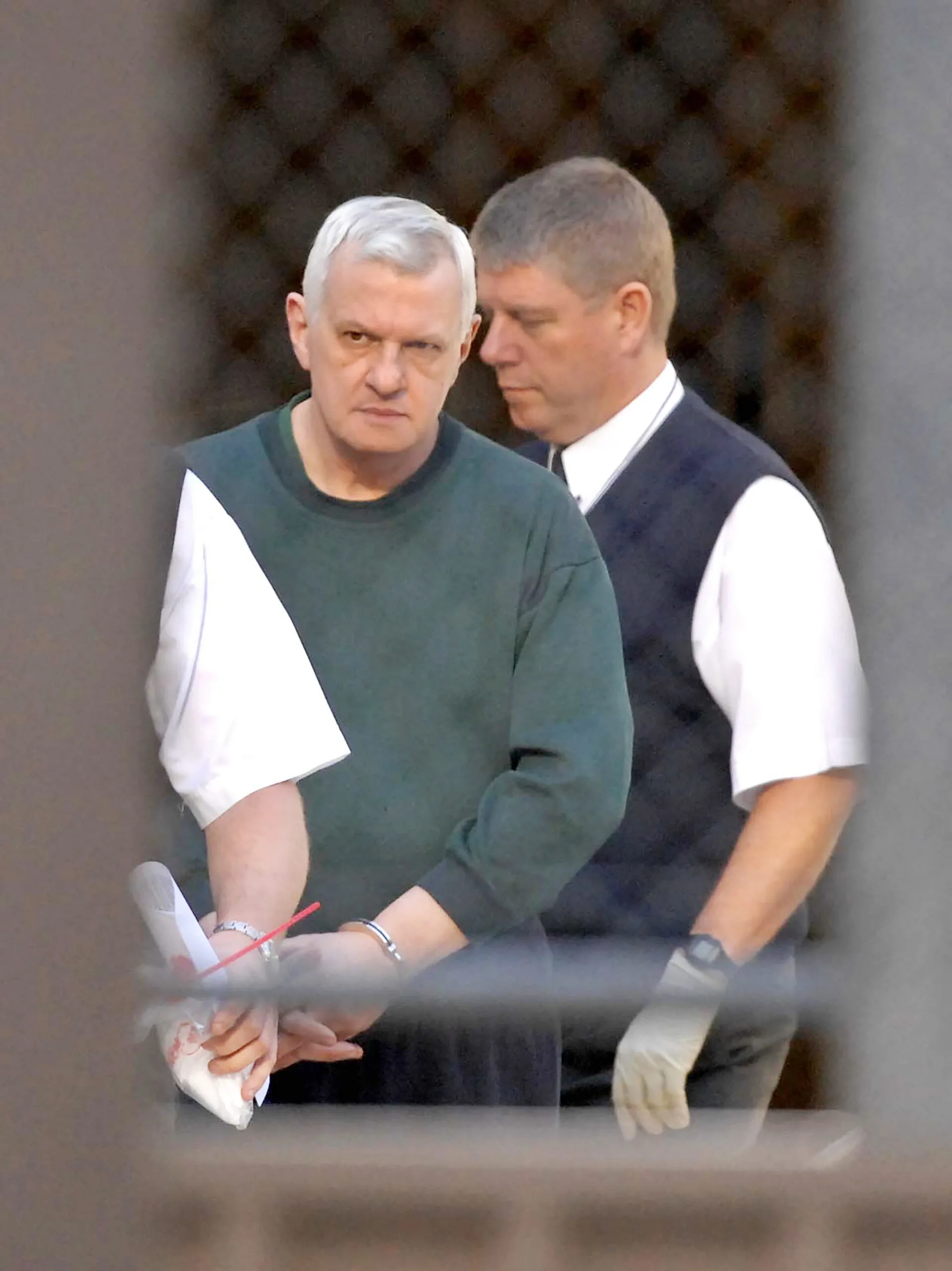 Bevan Spencer Von Einem in handcuffs