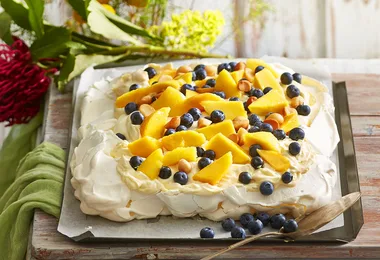 Pavlova with custard cream, mango and blueberries