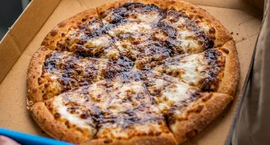 Forget pineapple, Vegemite pizza is officially here and fans are losing it